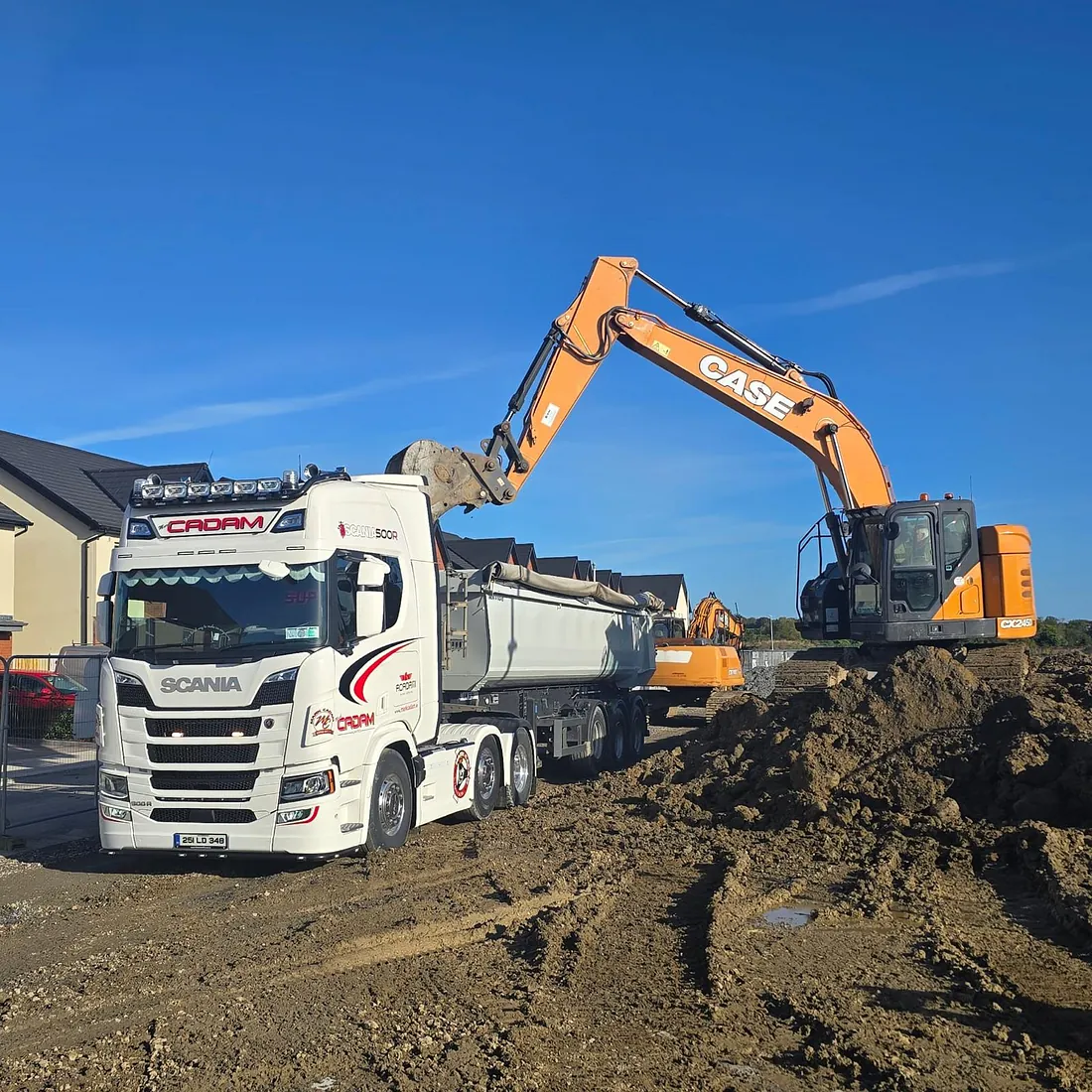 Digger dropping Soil into a dumper