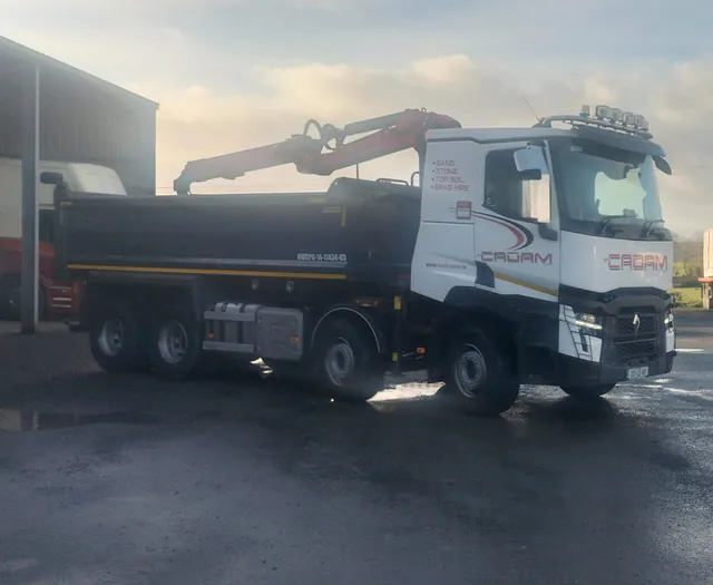 Digger Dropping sand into a trailer 