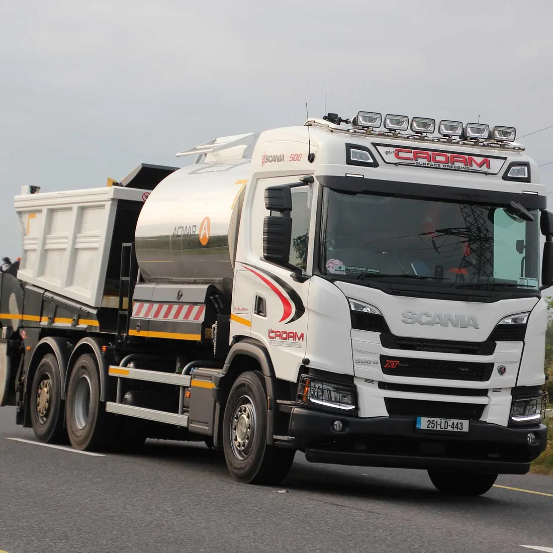Lorry hauling a tank